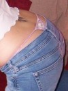 Teen bends over and lets her thong peak out from her jeans