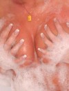 Carma grabs her huge tits in the bubble bath
