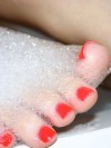 Amy shows off her cute painted toes in a bubble bath
