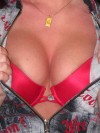 Carmas huge tits are almost popping out of her bright red bra
